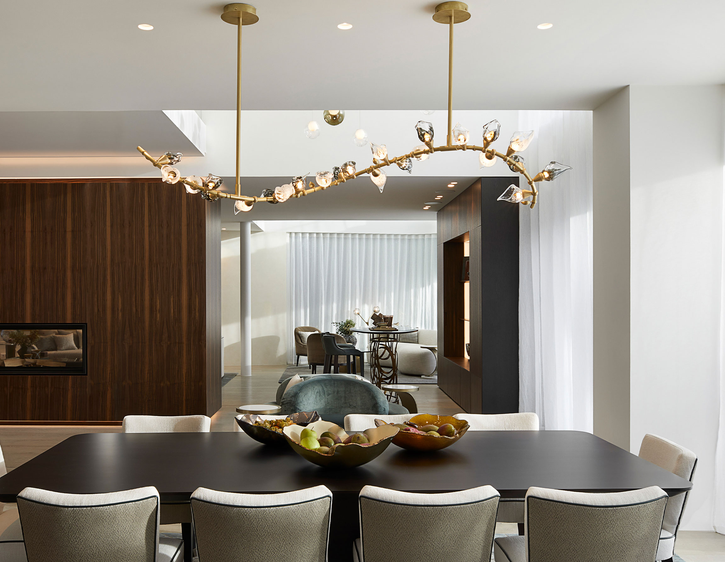 Chandelier with handblown glass flowers mounted on brass framework in dining room of luxury villa, custom-made by Nulty Bespoke