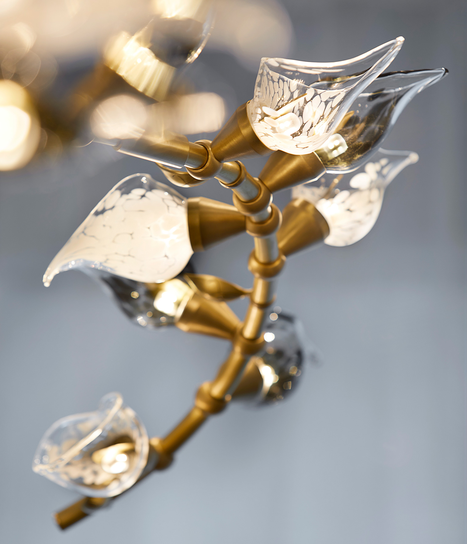 Luxury chandelier with calla lily-inspired handblown glass flowers mounted on brass framework, created by Nulty Bespoke